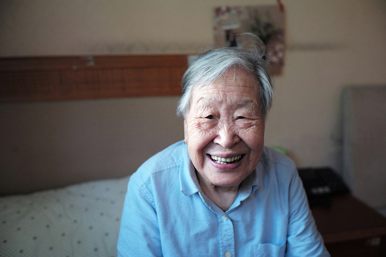 Smiling elderly woman in a blue shirt